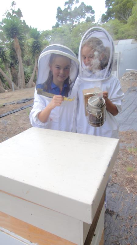 Both girls - showing hive tool and smoker
